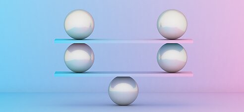 Metal balls balancing against a bright background