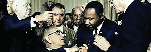 Martin Luther King, Jr. attends the signing of the Civil Rights Act