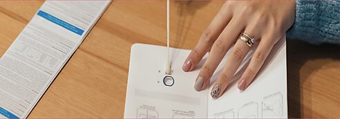 A woman inserts a swab into a covid test card