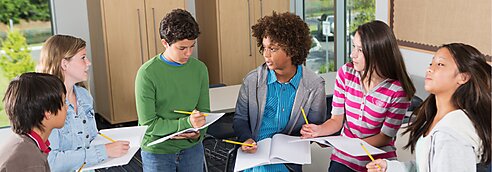 Kids talking and taking notes