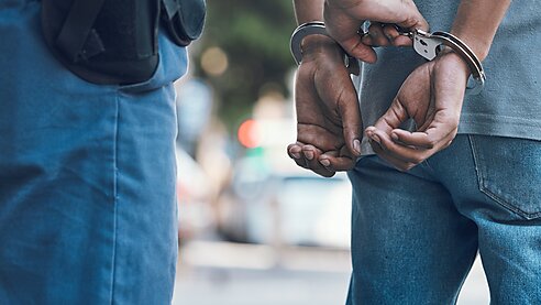 Man being placed in handcuffs