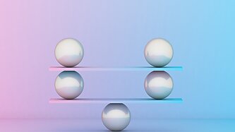 Metal balls balancing against a bright background